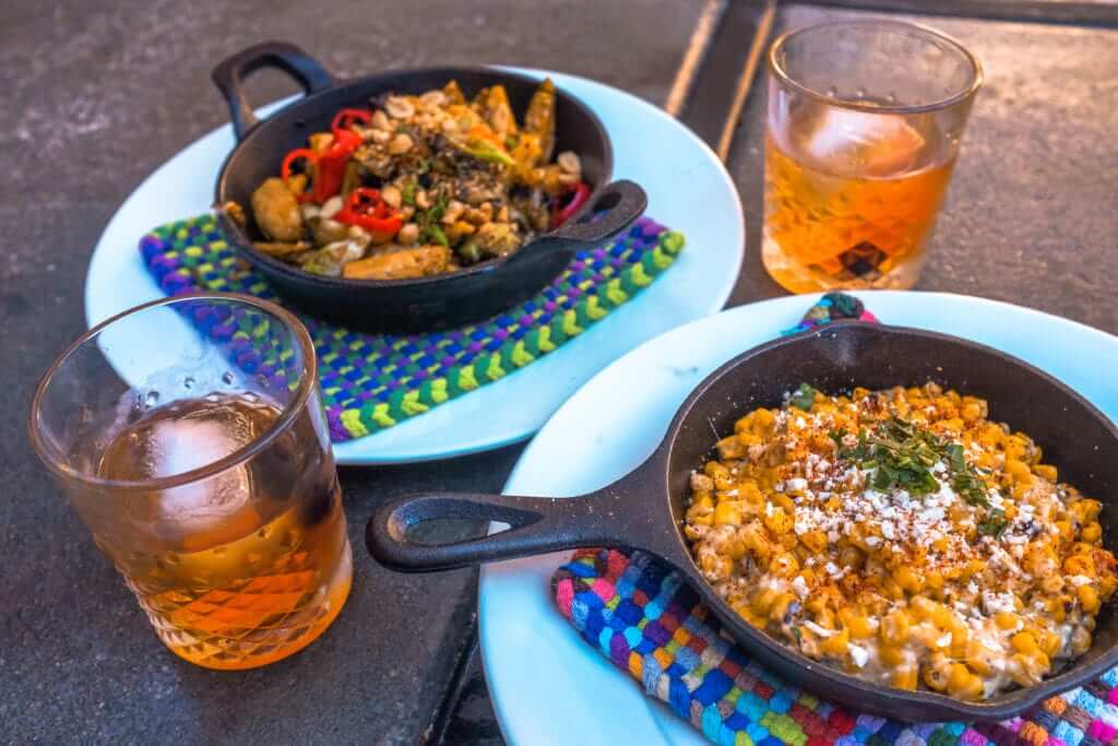 1865 Crafthouse in San Luis Obispo 2 skillet plates and two cocktails in rocks glasses from 1865 Crafthouse in San Luis Obispo